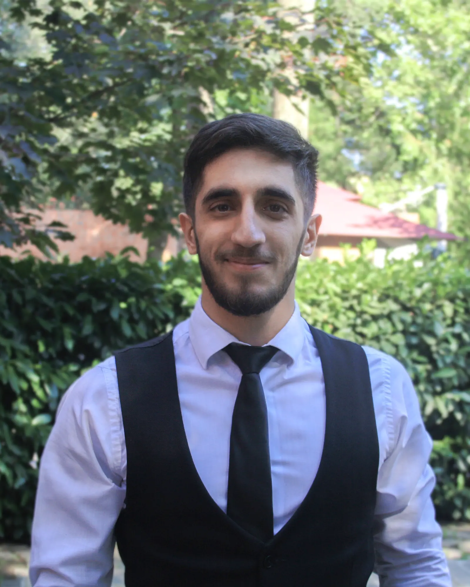 Gigi Gigiloshvili wearing a shirt, tie and waistcoat